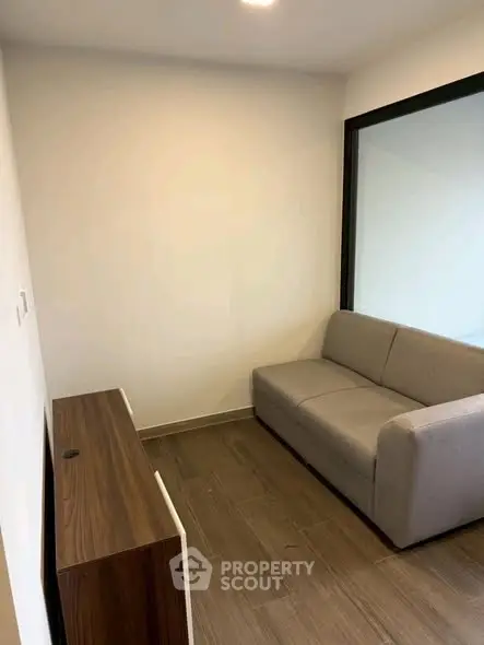 Cozy small living room with modern sofa and wooden flooring