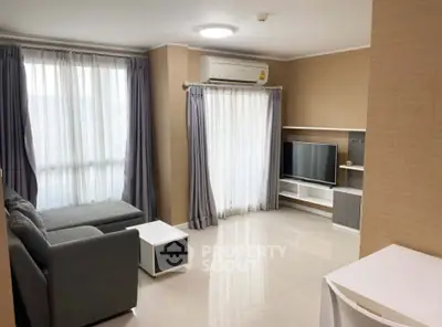 Modern living room with sleek furniture and natural light, perfect for relaxation and entertainment.
