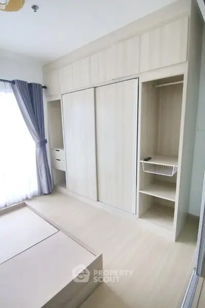 Modern bedroom with built-in wardrobe and natural light