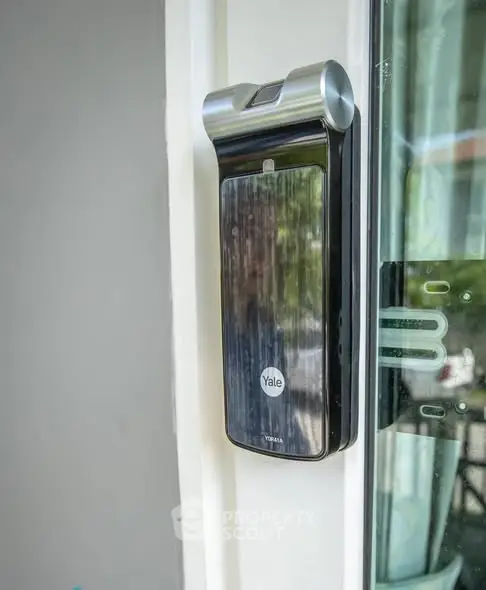 Modern smart lock on a glass door, enhancing home security with sleek design and advanced technology.