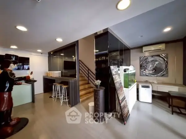 Modern interior with sleek design, featuring a staircase and stylish decor elements.