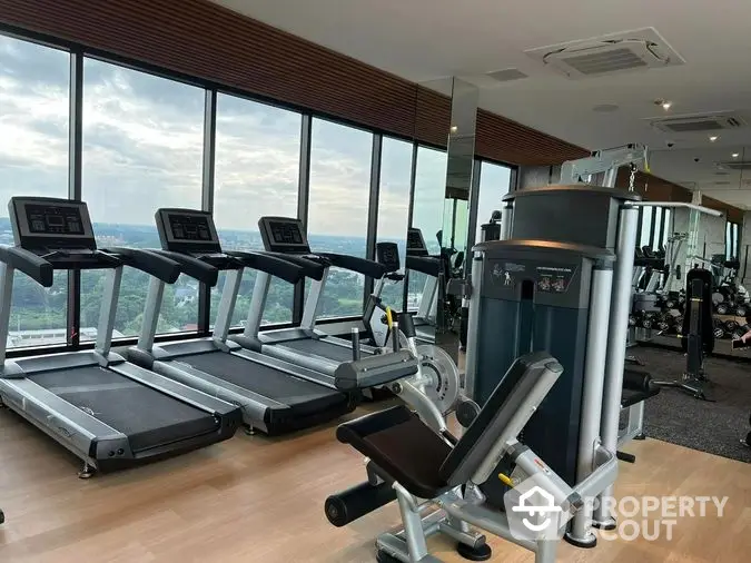 State-of-the-art fitness center with modern equipment and panoramic views, enhancing a luxurious lifestyle in a high-end property.