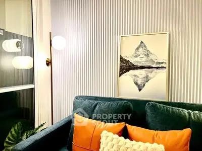 Stylish living room with modern decor and mountain artwork