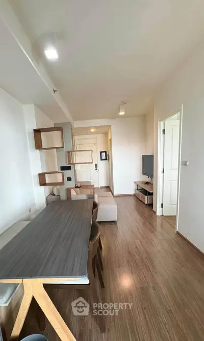 Modern living room with wooden flooring and stylish furniture in a contemporary apartment.