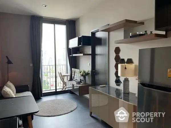 Modern studio apartment with integrated living space featuring sleek kitchen appliances, ample storage, and a cozy dining area leading to a sunlit balcony.