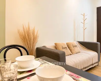 Cozy living room with stylish decor and dining setup, perfect for modern living.