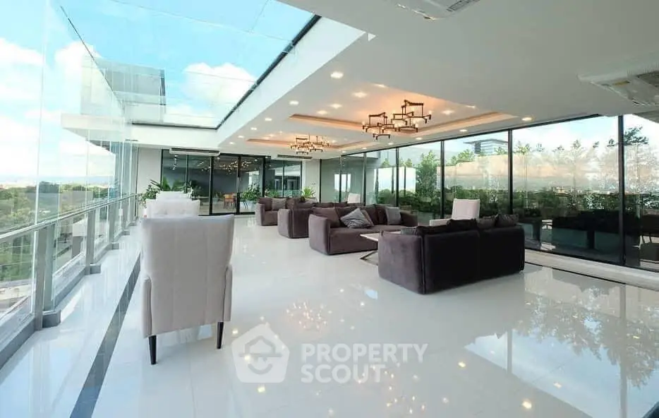 Luxurious modern living room with panoramic glass walls and elegant seating