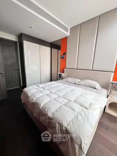 Modern bedroom with sleek design and cozy ambiance, featuring a comfortable bed and stylish decor.
