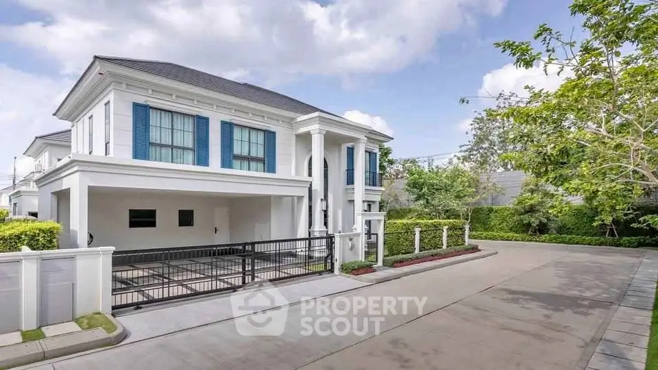 Elegant two-story house with modern architecture and spacious driveway in a serene neighborhood.