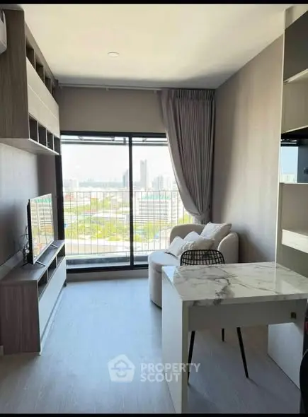 Modern living room with city view, stylish furniture, and natural light.