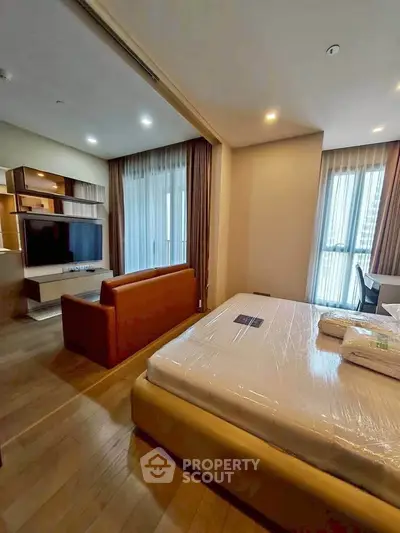 Modern studio apartment with open layout, featuring a cozy living area and stylish bedroom.