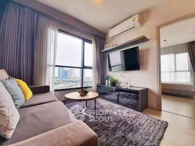 Modern living room with large windows, cozy sofa, and wall-mounted TV in a stylish apartment.
