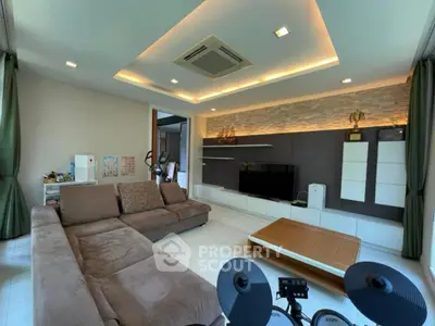 Spacious modern living room with stylish ceiling lights and cozy sectional sofa