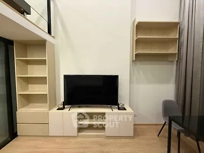 Modern living room with sleek TV unit and stylish shelving in a contemporary apartment.