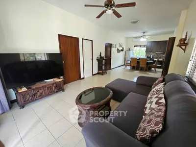 Spacious living room with modern decor and open layout to dining area