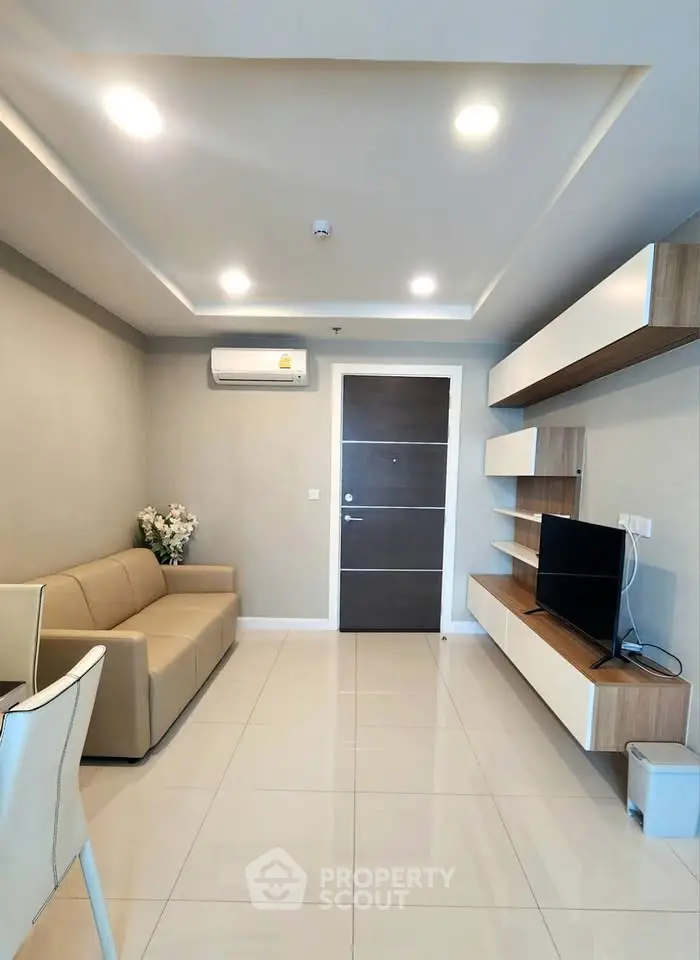 Modern living room with sleek furniture and ambient lighting, perfect for cozy gatherings.