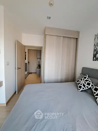 Modern bedroom with stylish decor and sliding wardrobe doors in a contemporary apartment.