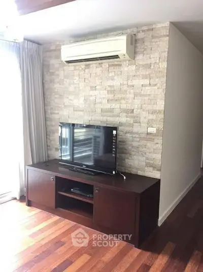 Stylish living room with wooden flooring and modern entertainment setup