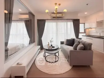 Modern living room with elegant decor and open kitchen layout in a high-rise apartment.