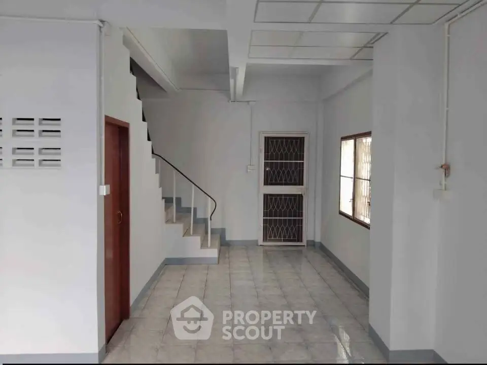 Spacious interior with staircase and tiled flooring, ideal for modern living.