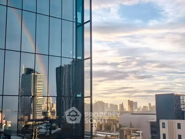 Stunning cityscape view with modern glass building reflecting a rainbow, perfect for urban living enthusiasts.