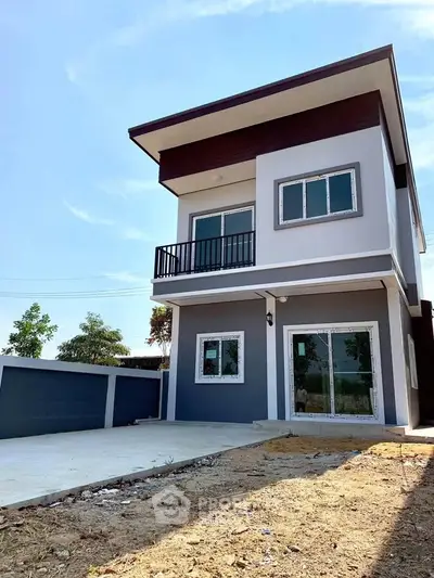 Modern two-story house with sleek design and spacious driveway