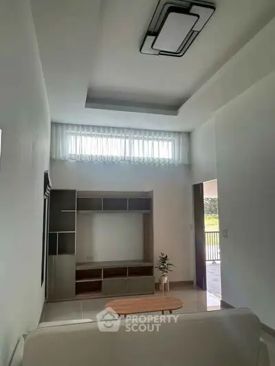 Modern living room with sleek furniture and natural light, ideal for contemporary living.