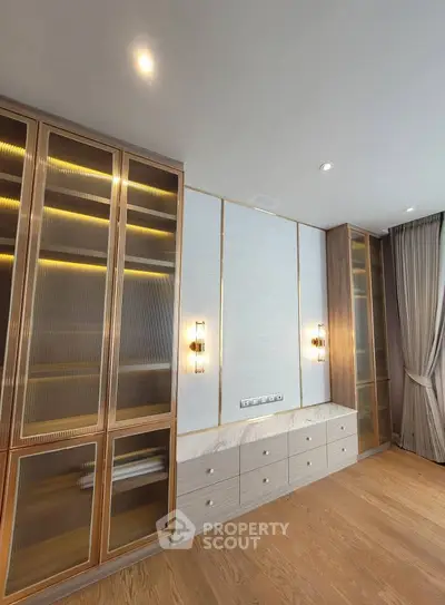 Luxurious modern living room with elegant built-in storage and ambient lighting.