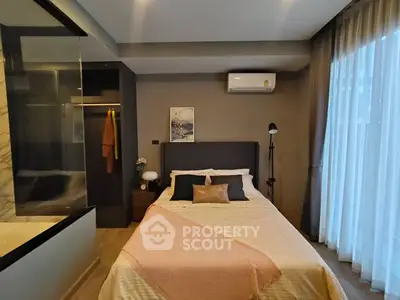 Modern bedroom with stylish decor and natural light from large window