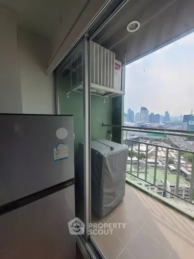 High-rise balcony with city view and modern appliances, perfect for urban living.