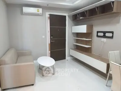 Modern living room with sleek furniture and wall-mounted shelves in a stylish apartment.