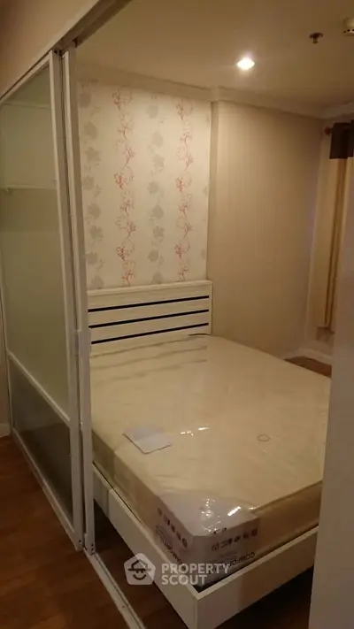 Cozy bedroom with modern design and sliding glass door, perfect for urban living.