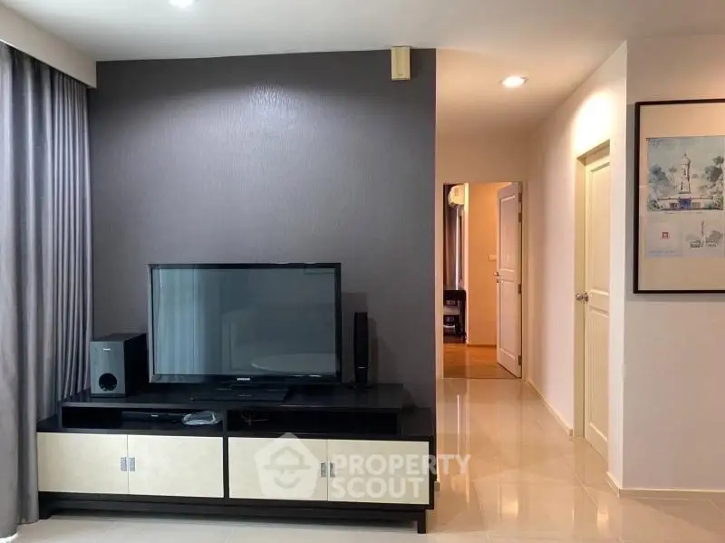 Modern living room with sleek TV stand and neutral decor, perfect for relaxation and entertainment.