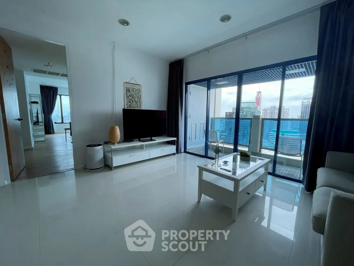 Spacious modern living room with city view and large balcony access.