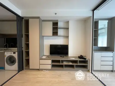 Modern studio apartment with integrated living space featuring sleek built-in storage, a cozy entertainment area, and a convenient kitchen with modern appliances.