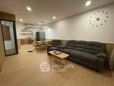 Modern living room with open kitchen layout and stylish furniture