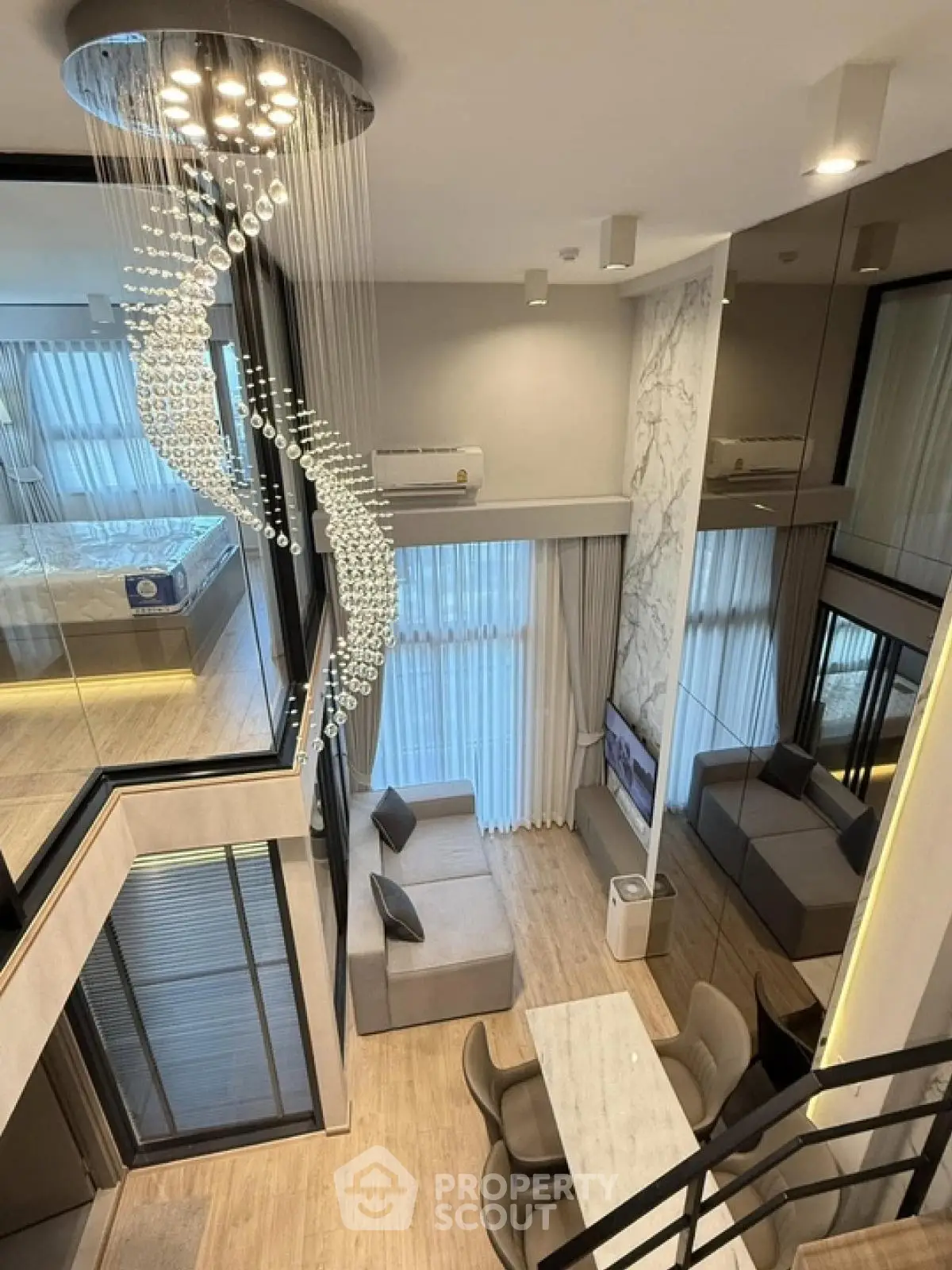 Luxurious modern duplex with elegant chandelier and stylish decor