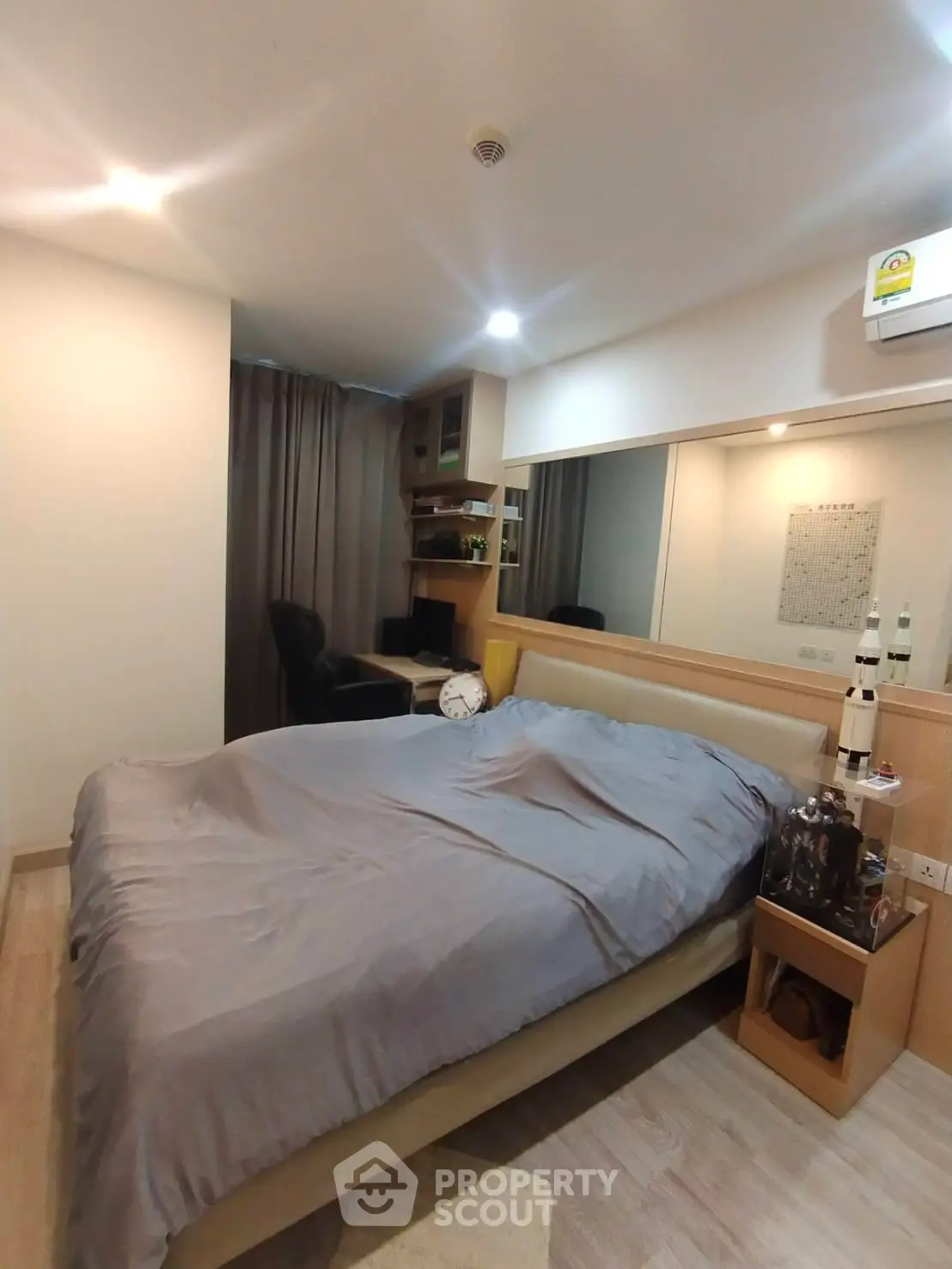 Cozy bedroom with modern decor and study area, perfect for urban living.