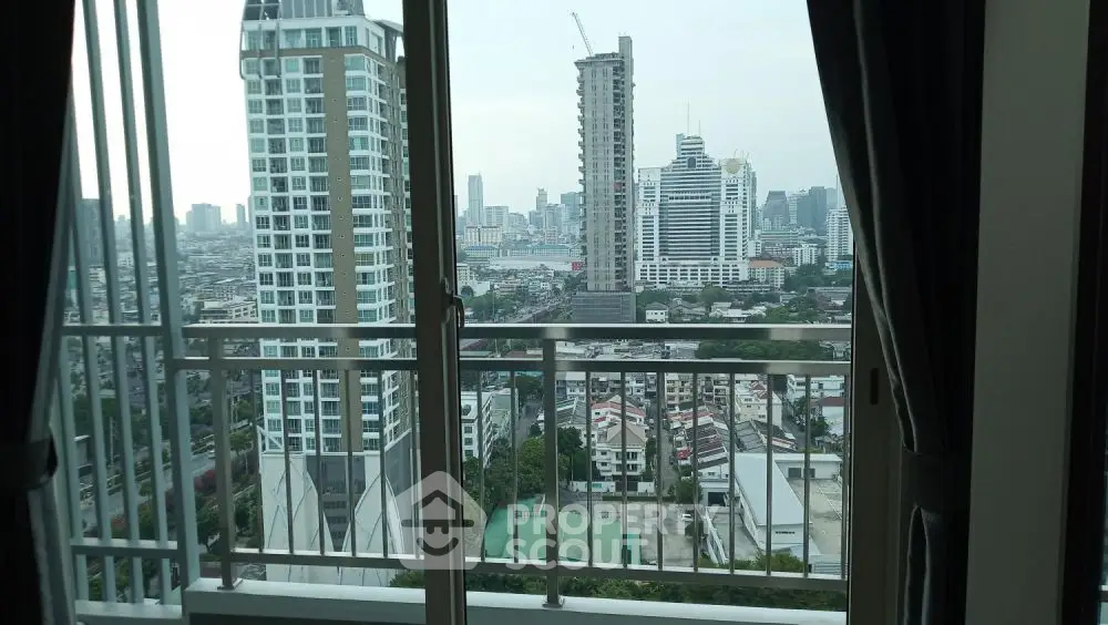 Stunning urban cityscape view from high-rise apartment balcony.