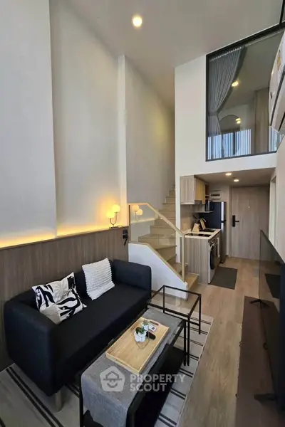 Modern loft apartment with stylish living room and open kitchen layout