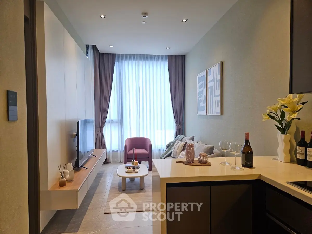 Modern living room with stylish decor, large window, and cozy seating area, perfect for relaxation and entertainment.