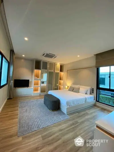 Spacious modern bedroom with large windows and stylish decor