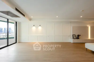 Spacious modern living room with city view and elegant wood flooring
