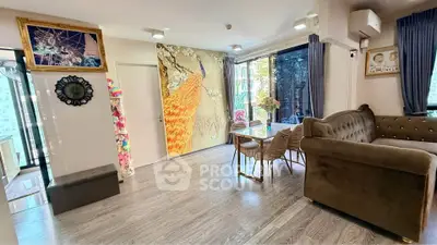 Spacious living room with elegant decor and large windows offering natural light.