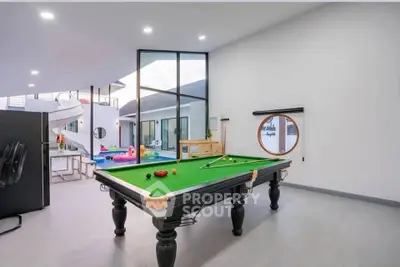 Luxurious modern interior with pool table and spiral staircase, perfect for entertainment.