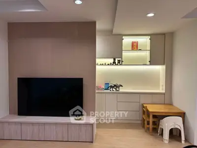 Modern living room with sleek TV unit and cozy dining nook