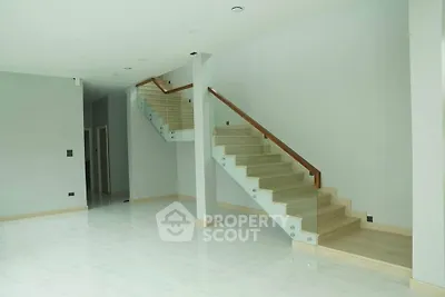 Spacious modern interior with elegant staircase and glossy flooring