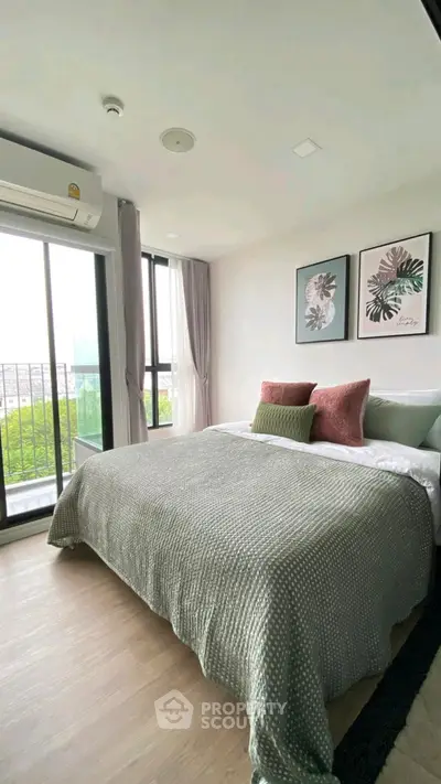 Modern bedroom with large windows and stylish decor, offering a serene and inviting atmosphere.