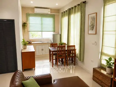 Charming living room with natural light, cozy seating, and a dining area, perfect for relaxation and entertaining.