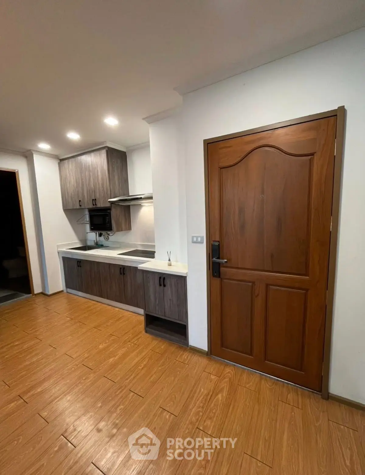 Modern kitchen with wooden cabinets and sleek design in a cozy apartment